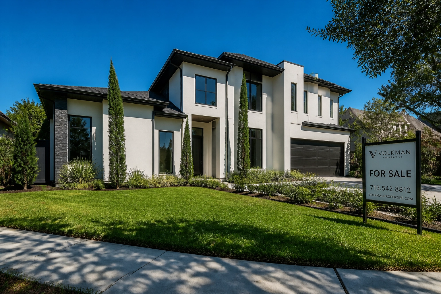 Contemporary Houston single-family home for sale with a manicured front lawn and blue sky.