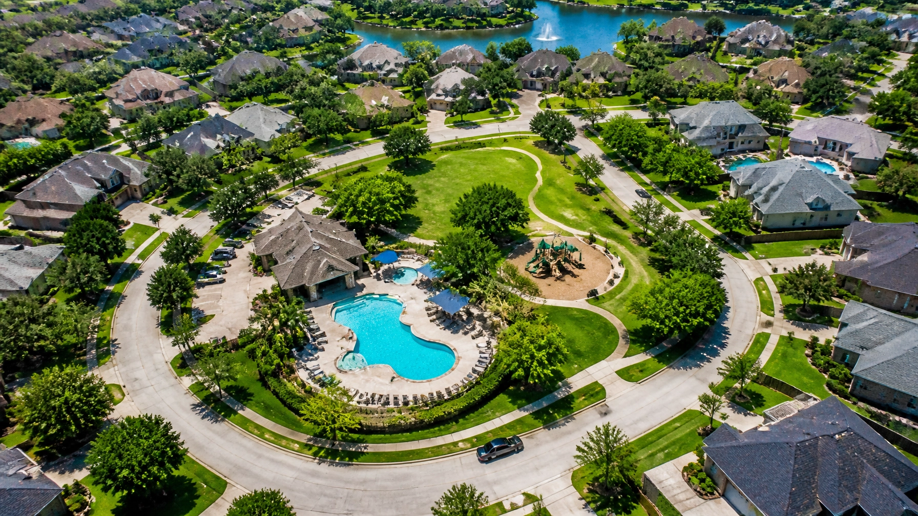 Aerial view of a Houston suburban neighborhood with community amenities that contribute to HOA and MUD costs