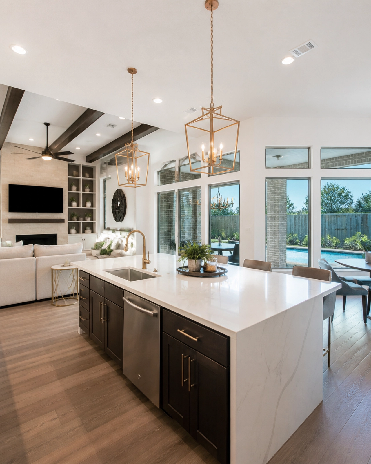 A luxury open-concept kitchen and living room in a Sugar Land home, showcasing modern finishes and high-end real estate appeal.