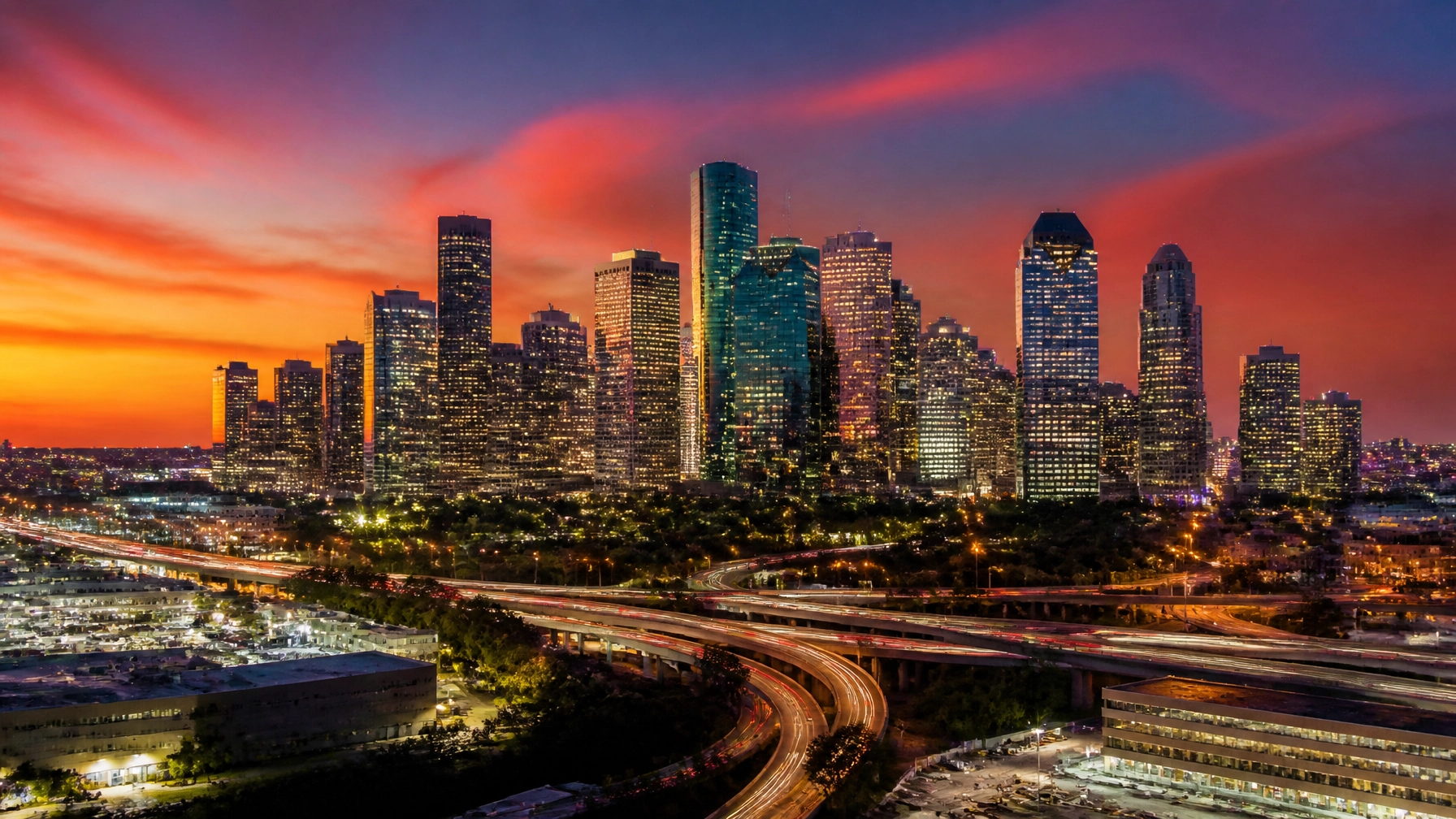 The Houston skyline at sunset with a warm glow