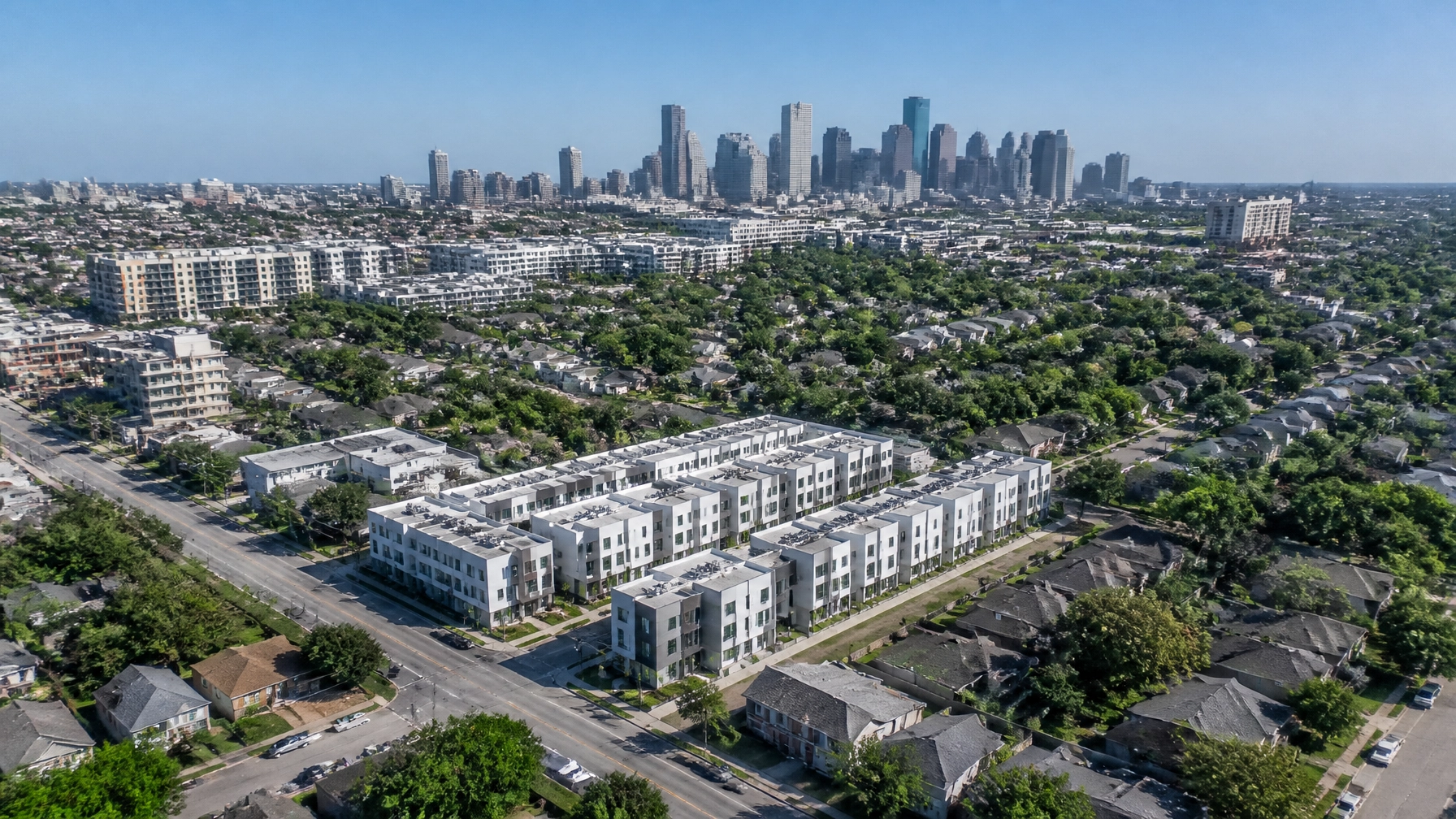 An aerial view of Houston showing the mix of residential single-family neighborhoods and new townhome developments.