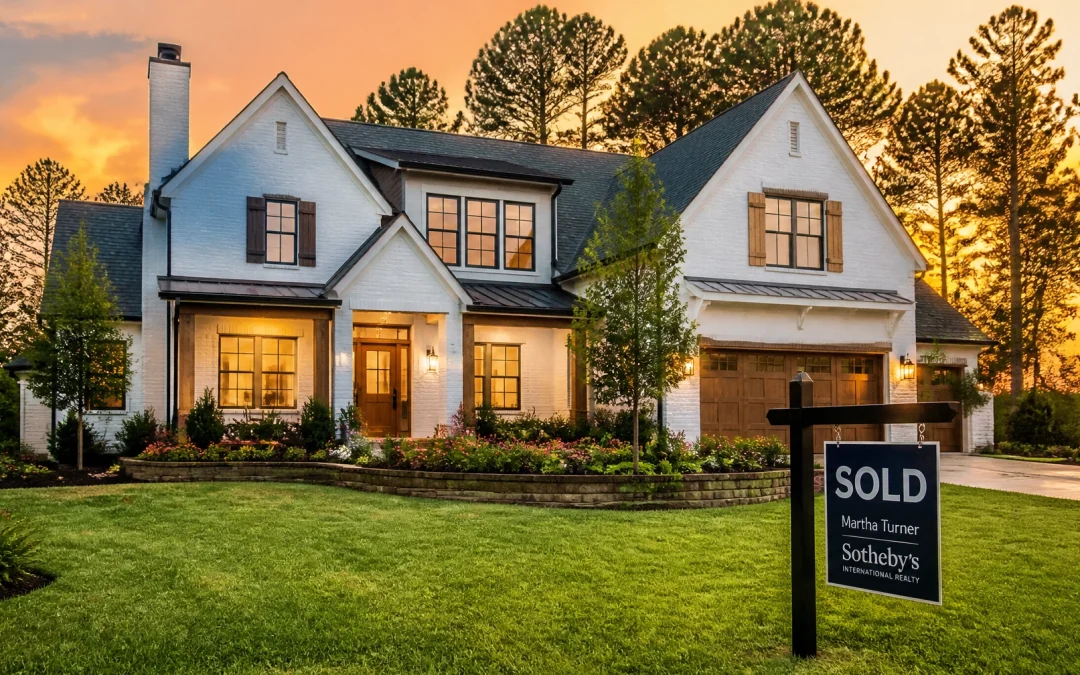 A luxurious modern Houston home with a SOLD sign at sunset