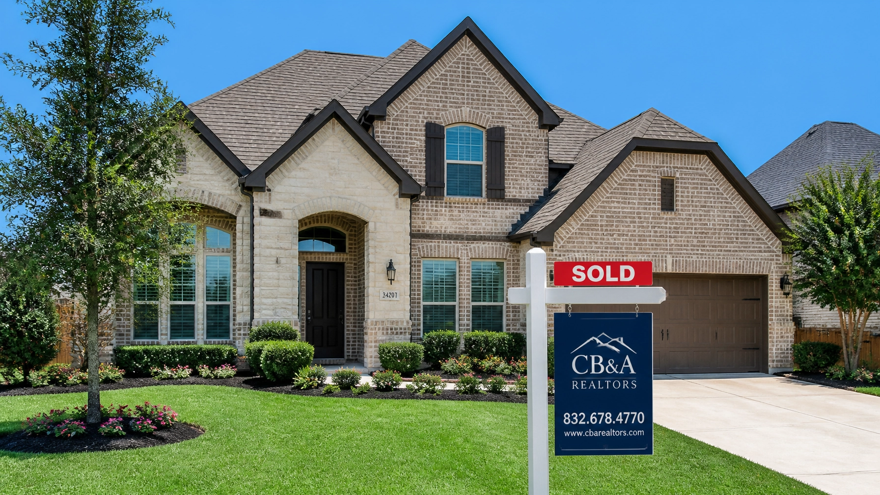 A beautiful Houston home with a SOLD sign in the yard