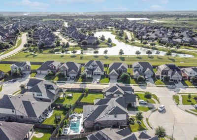 Aerial view of homes and pond at 26107 Pond Lily Circle, Richmond, TX