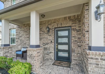 Featured Katy, Texas property with brick facade and front porch.
