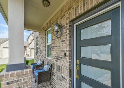 Featured Katy, Texas home exterior and front porch with blue door.