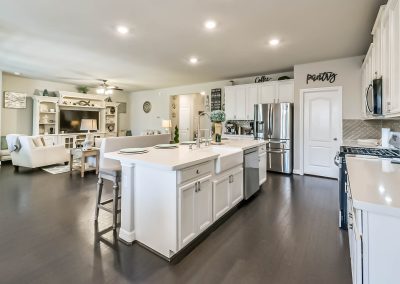 Modern Katy, Texas kitchen with large island and stainless steel appliances in Bexley Realty Group listing.