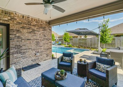 Outdoor patio and pool area of a Katy, Texas property for sale.