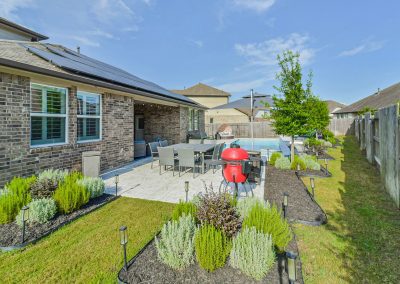 Backyard patio and pool area of a Katy, Texas property for sale.