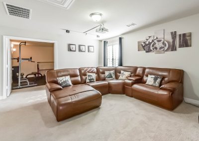 Luxury home living room with sectional sofa and media room.