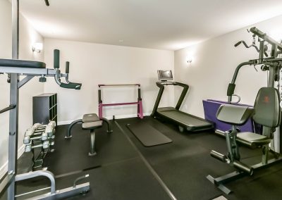 Home gym with exercise equipment and fitness area for sale in Katy, Texas.