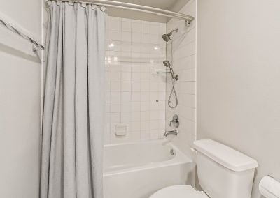 Bathroom with shower and tub in Katy, Texas property listing.