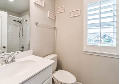Interior bathroom with shower, toilet, and window in Katy, Texas property listing.