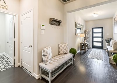 Interior view of Katy, Texas home for sale and stylish entryway with bench and decor.