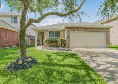 Richwood Oaks Drive home in Katy, Texas, featuring brick facade and well-manicured lawn