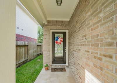Exterior view of Katy, Texas home for sale with patriotic wreath on front door.