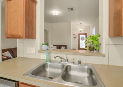 Interior view of a Katy, Texas home for sale and modern kitchen with stainless steel sink.