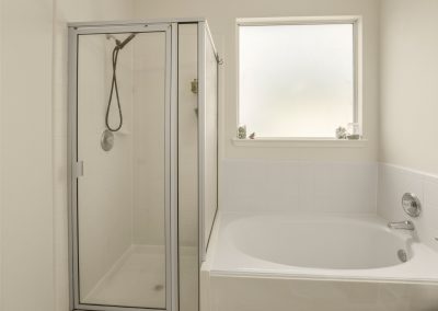 Bathroom interior with shower and tub in Katy, Texas property listing.