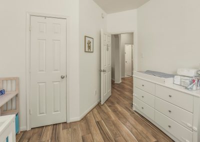 Interior view of Katy, Texas home featuring bedroom with closet and changing table.
