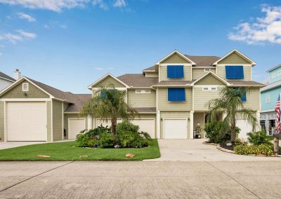 Large two-story home with palm trees and garage in Galveston, Texas for sale by Bexley Realty Group