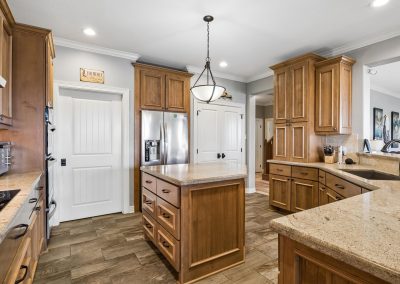 Luxury kitchen with wood cabinetry and stainless steel appliances in Galveston, Texas property.