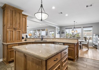 Luxury kitchen with wood cabinetry and granite countertops in Galveston, Texas home for sale.