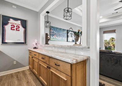 Luxury home interior with custom cabinetry and framed sports memorabilia in Galveston, Texas.