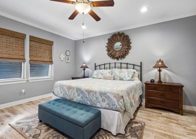 Bedroom interior with queen bed and wood accents in Galveston, Texas property.
