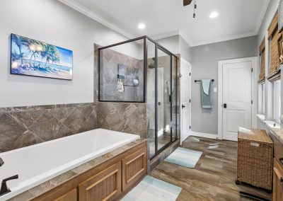 Luxurious bathroom with walk-in shower and soaking tub, featured property in Galveston, Texas.
