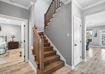 Interior view of luxury home staircase and entryway in Galveston, Texas property for sale.