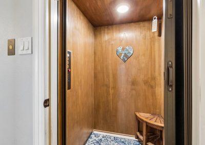 Luxury elevator interior with decorative heart and wood paneling in Galveston, Texas property.