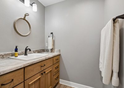 Modern bathroom interior with vanity and decorative mirror, featured property in Katy, TX by Bexley Realty Group.