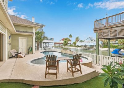 Luxury waterfront property with pool and boat dock in Galveston, Texas.