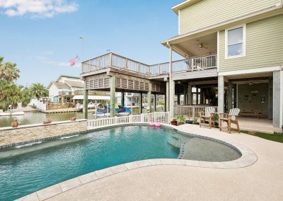 Luxury waterfront home with pool and boat lift in Galveston, Texas.