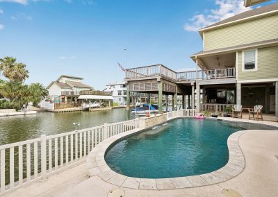 Luxury waterfront home with pool and boat dock in Galveston, Texas.