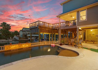 Luxury waterfront home in Galveston, Texas with pool and deck.