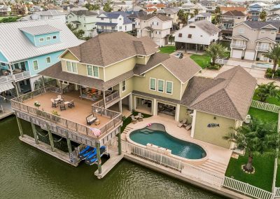 Luxury waterfront home in Galveston, Texas with pool and deck.