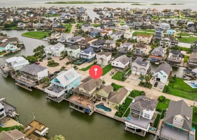 Aerial view of waterfront property in Galveston, Texas, with location marker.